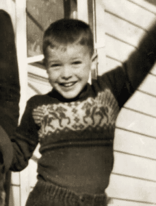 An image of Fr. Richard Rohr at 5 years old in a winter sweater excited to announce the birth of his sister.