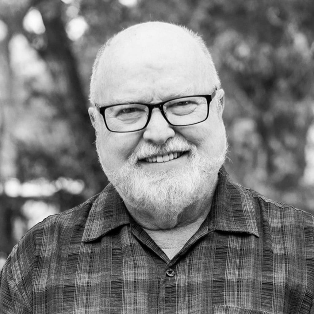 Richard Rohr Smiling In Front Of A Group Of Trees