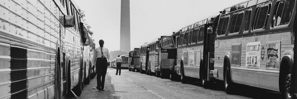 Image credit: U.S. Information Agency. Press and Publications Service. ca. 1953–ca. 1978, Civil Rights March on Washington, D.C. Two long lines of some of the buses used to transport marchers to Washington (detail), photograph, public domain.