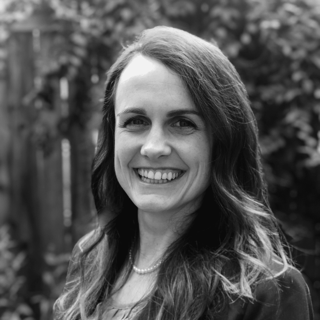 Black and white photo of Anna Johnson, smiling and facing the camera